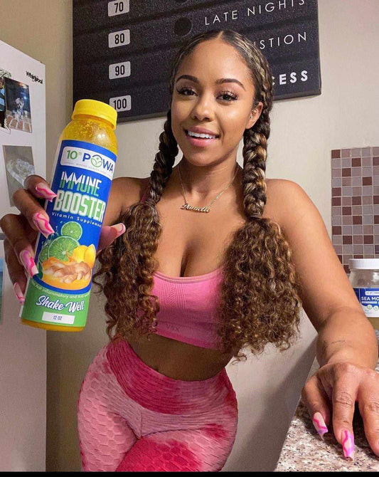 Bottle of herbal immune booster supplement with natural ingredients like onion, cayenne pepper, key lime juice, and turmeric root